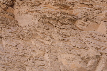 stone wall in the desert. beige rock wall texture. luxury natural rocky scenery. template for creative design of layout.