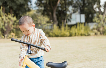 Asian Boys practice riding a balance car outdoors