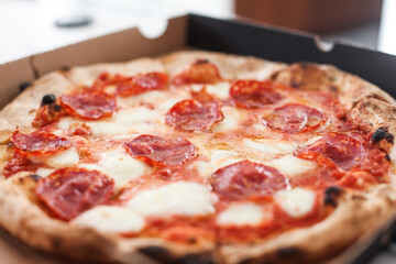 Hot pepperoni pizza in a delivery box