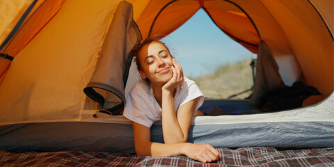 Dreamy lazy woman feeling good and enjoys free camping life during summer vacation.