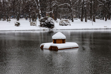 Scenic view of duck island-house in water in a winter season.