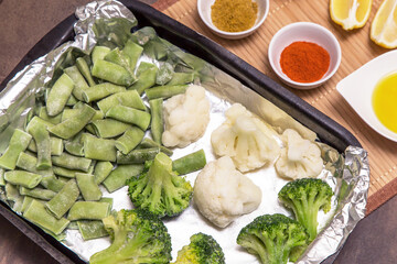 Frozen vegetables broccoli, string beans and cauliflower for cooking in foil in oven. Vegan vegetarian healthy diet food 