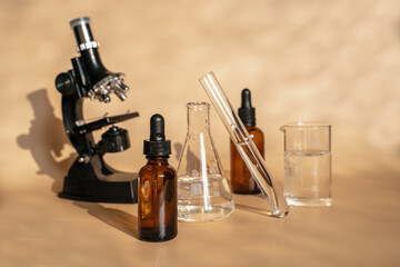Essence for skin health on a beige  background. laboratory where cosmetics are created.  Unisex cosmetics for men and women. Laboratory research of cosmetics for natural ingredients