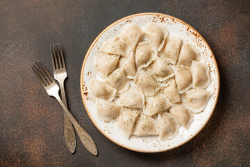 Dumplings on vintage plate on rusted metallic surface