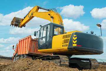 A large construction excavator of yellow color on the construction site in a quarry for quarrying. Industrial image
