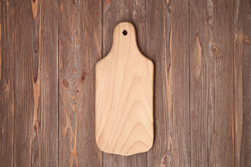 Blank wood cutting board on the brown table backround with copy space