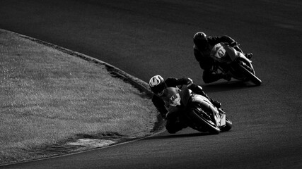 A shot of a racing motorbike as it circuits a track.