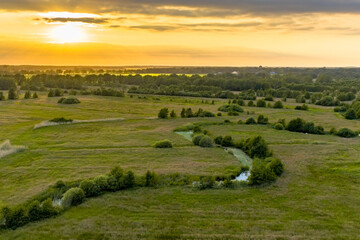 Fototapeta na wymiar Aerial view of green grassland river valley