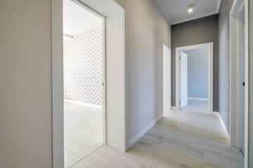 long white empty corridor in interior of entrance hall of modern apartments, office or clinic