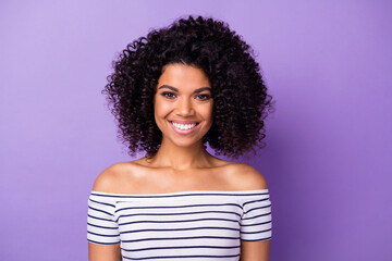 Portrait of adorable cheerful dark skin lady toothy smile look camera isolated on purple color background