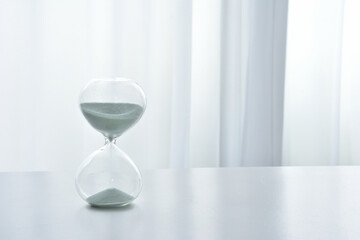 Hourglass on a white desk