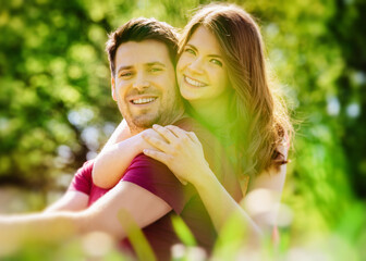 Happy lovely young couple in love spending time outdoors