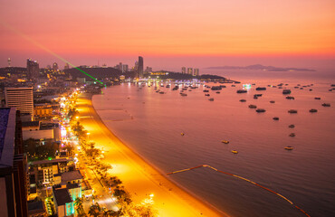 Majestic sunset view over the Gulf of Thailand and the coastline of Pattaya with urban cityscape