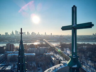 Beautiful panoramic aerial drone view of the Warsaw City Centre through two church towers with huge...