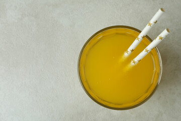 Obraz na płótnie Canvas Glass of orange soda on white textured background