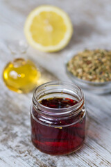 A bottle with tea, lemon and honey