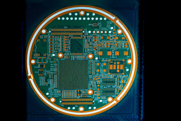 Round printed circuit board. Printed circuit board with luminous elements. Round PCB. PCB on a dark...