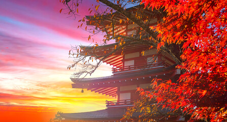 Traditional Japanese landscape. Pagoda in Japan. Red maple tree next to a Buddhist temple. Japanese maple tree during dawn. Japanese temple pagoda on sky background. Japan sunrise.