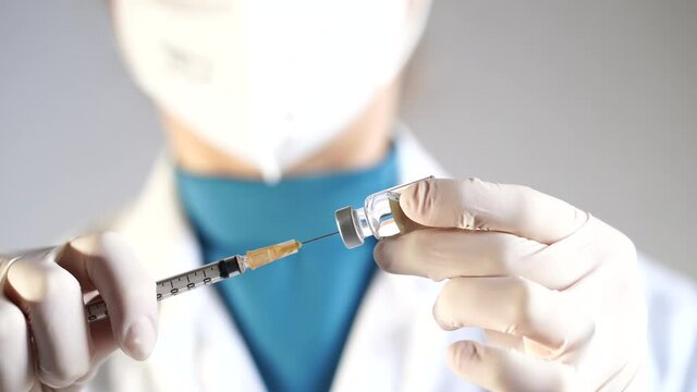doctor holding syringe