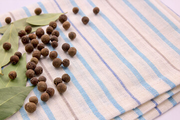 A bunch of allspice on a kitchen towel.