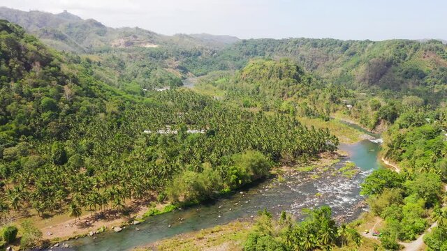 Aerial view of River in the mountains among the rainforest. Mindanao, Philippines. Cagayan de Oro river.
