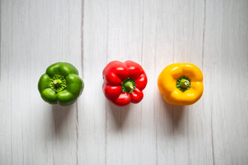 sweet pepper, red, green, yellow paprika, on wooden background. Fresh, sweet, colorful bell peppers