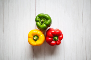 sweet pepper, red, green, yellow paprika, on wooden background. Fresh, sweet, colorful bell peppers
