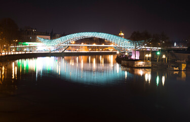 bridge over the river at night with colourful backlight and reflection 