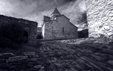 Fototapeta premium old fortress building with dramatic sky in black and white 