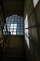 Light is passing through the window and a shadow is forming on the wall 