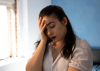 Woman with a disappointed face in front of the mirror