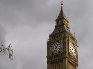 Fototapeta na wymiar London, United Kingdom - March 25 2005: Westminster palace with the tower bell called Big Ben, in a sunny day.