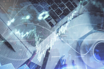 Double exposure of financial chart drawing over table background with computer. Concept of research and analysis. Top view.