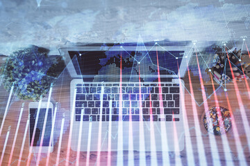 Multi exposure of financial chart drawing over table background with computer. Concept of research and analysis. Top view.