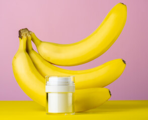 White mock up bottle and bananas pink yellow background, beauty care concept