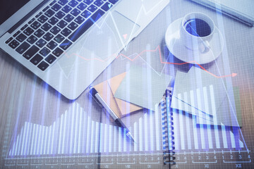 Obraz premium Stock market graph and top view computer on the table background. Double exposure. Concept of financial education.