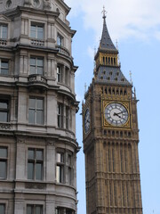 Fototapeta na wymiar London, United Kingdom - March 25 2005: Westminster palace with the tower bell called Big Ben, in a sunny day.