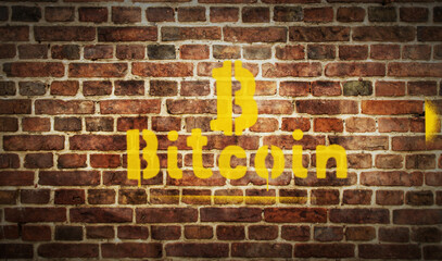 Fototapeta na wymiar Bitcoin spray painted inscription on the brick wall