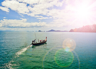 Ranong, Thailand - December 2018: A long-tailed boat sails along the Andaman Sea to the islands, taking tourists on an excursion.