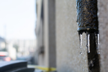 Some drops falling some ice stalactites during the cold wave in Tours city France
