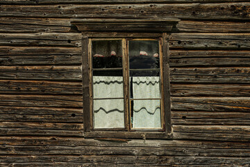 Obraz na płótnie Canvas Old skewed window in a timber wall
