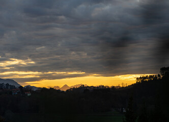 beautiful sunset in the mountains with beautiful colors in a natural environment with trees
