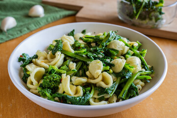 Typical dish of Italian cuisine, orecchiette with turnip greens. Vegan food, healthy dish, fast lunch. Orecchiette con cime di rapa.