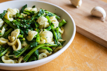 Typical dish of Italian cuisine, orecchiette with turnip greens. Vegan food, healthy dish, fast lunch. Orecchiette con cime di rapa.