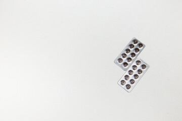 medicines in the form of tablets capsules on a white background top view