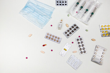 medicines in the form of tablets capsules on a white background top view