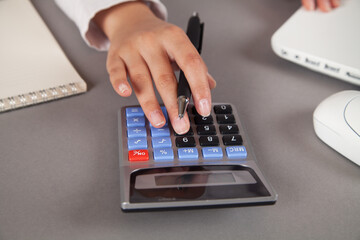Woman accountant working with calculator for business and financial expense.