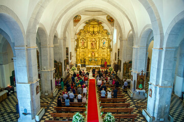 CHURCH INTERIOR DURING A WEDDING CELEBRATION