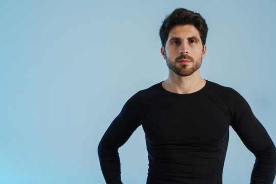 Young athletic sportsman posing and looking at camera