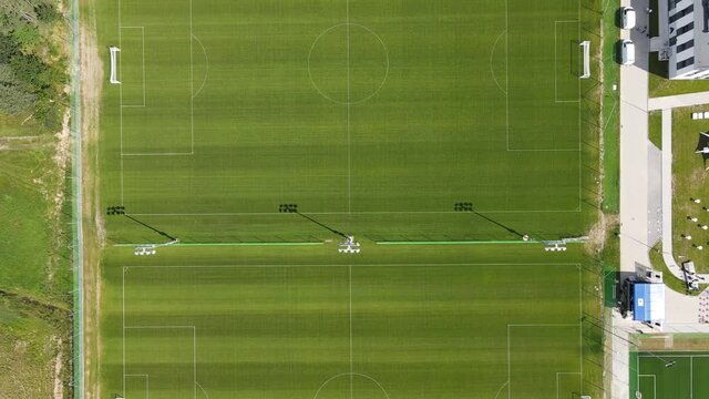 drone footage top down, big green empty soccer field